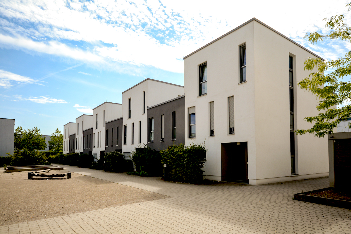 Modern townhouses in a residential area, new apartment buildings with green outdoor facilities in the city